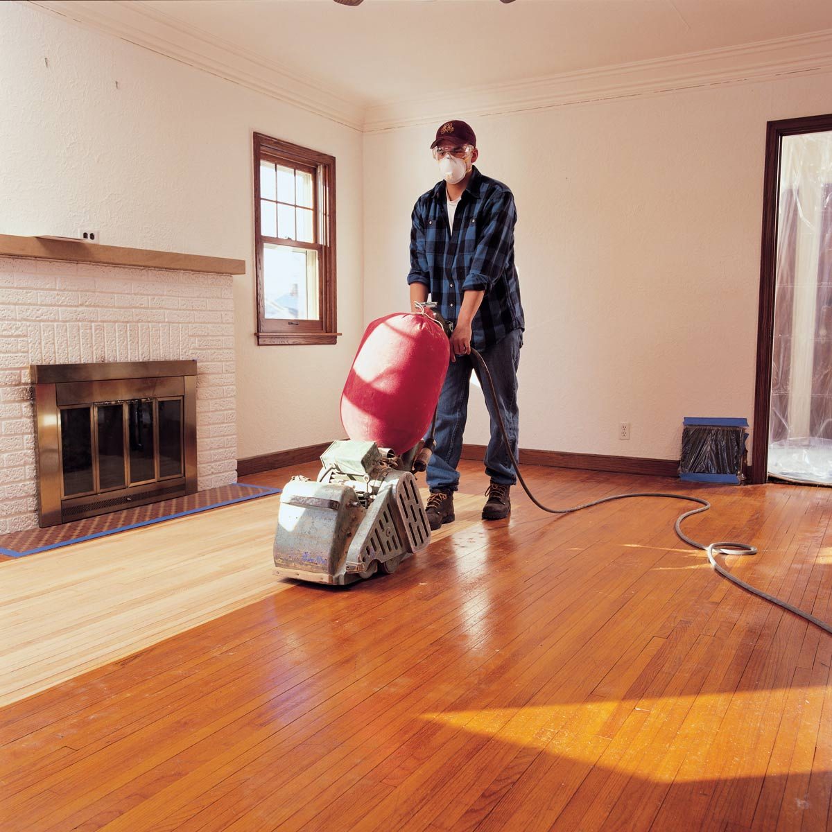 Man-walks-behind-floor-sanding-machine