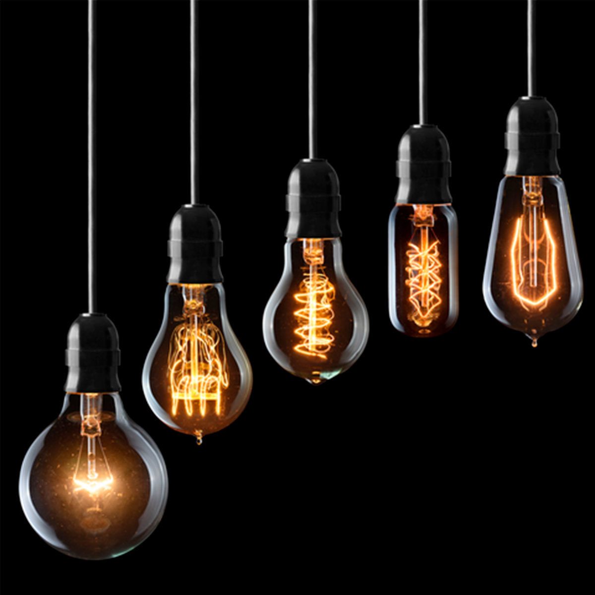 Five hanging light bulbs illuminate with intricate filament designs against a black background, showcasing various shapes and glowing patterns.