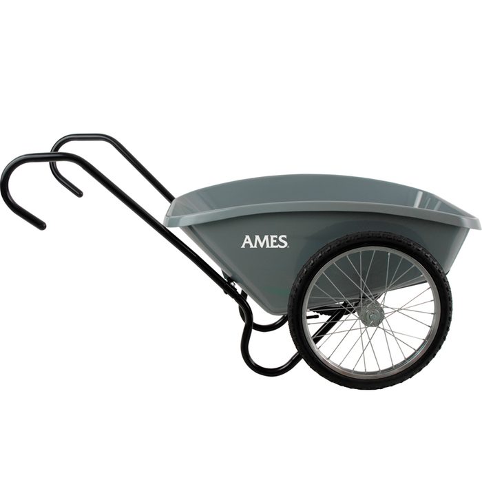 A gray wheelbarrow with metallic black handles and a single wheel stands upright, designed for transporting materials in a construction or gardening context.