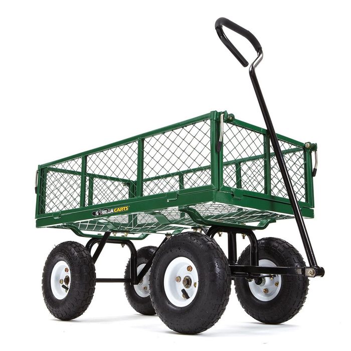 A green metal garden cart with a mesh design, equipped with four large black tires and a curved handle for pulling, stands ready for use.