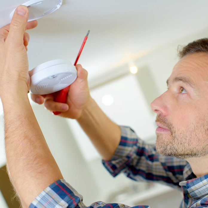 Man installing a smoke alarm