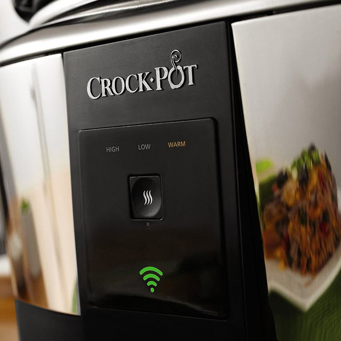A Crock-Pot is displayed, showing controls for cooking settings and a Wi-Fi indicator, alongside a reflective surface hinting at food.
