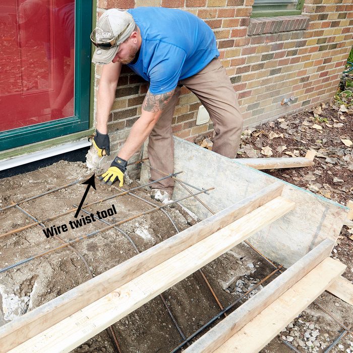 Twisting wire around rebar joints to hold them together | Construction Pro Tips