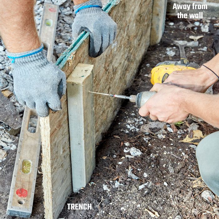 Screwing in the forms from the back | Construction Pro Tips