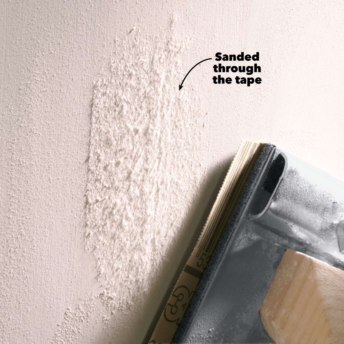 A sanded area on a wall reveals a textured surface, with a sanding tool resting beside it, indicating preparation for further finishing work.