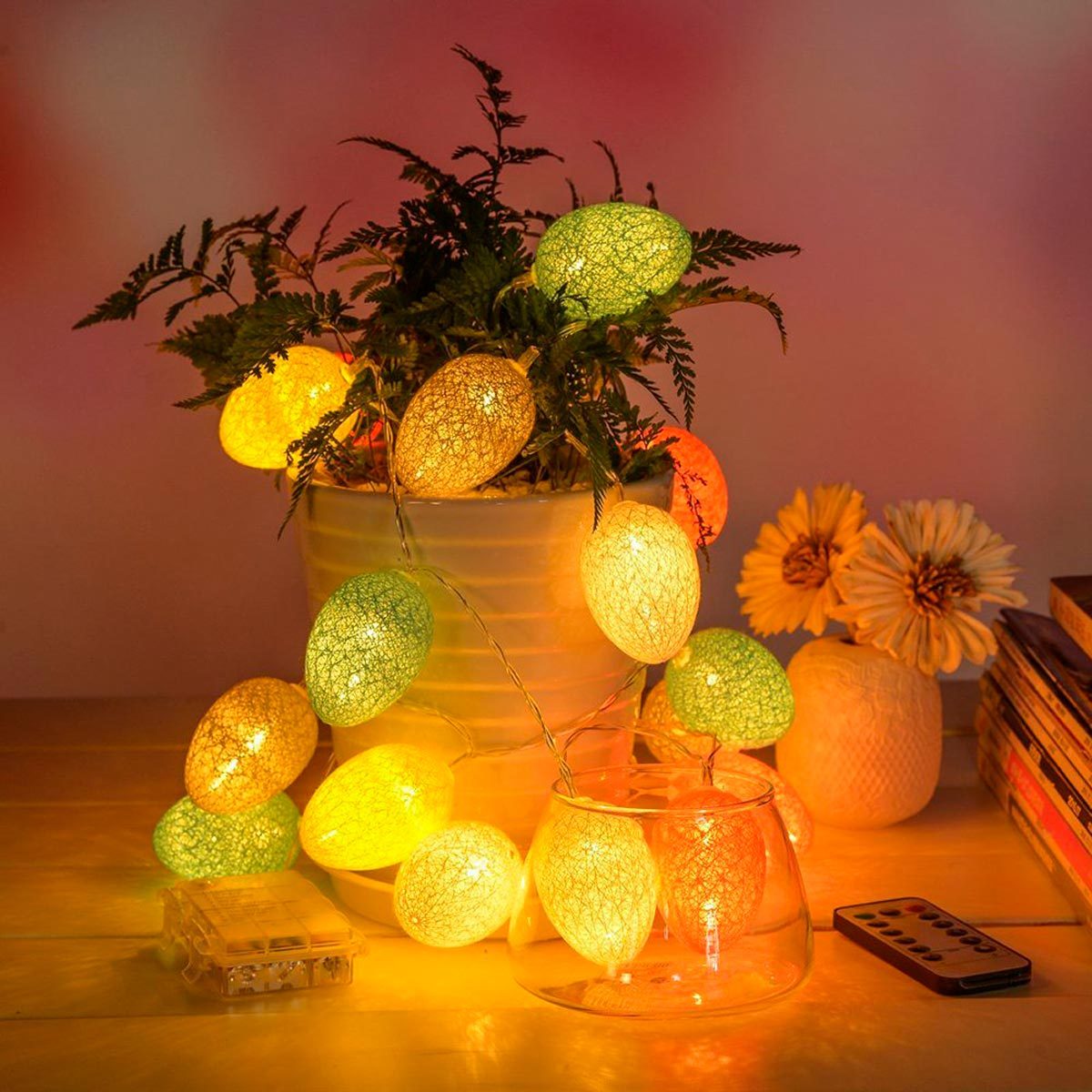 A illuminated vertical panel emits cascading light particles, enhancing a modern living room with a glass table, ornamental vase, and decorative items.