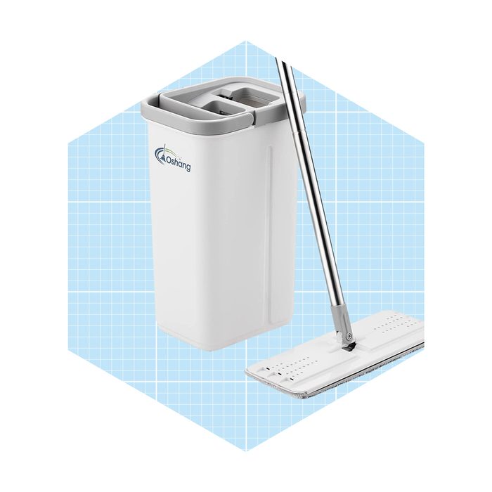 A mop stands beside a rectangular trash bin with a divided lid, set against a light blue grid background.