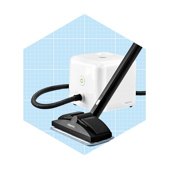 A steam cleaner with a black handle and nozzle is positioned next to a white base unit, set against a light blue grid background.