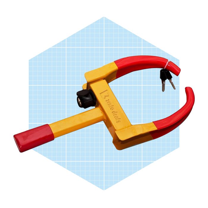 A yellow and red device with a locking mechanism is shown, designed for securing an object, set against a light blue grid background.