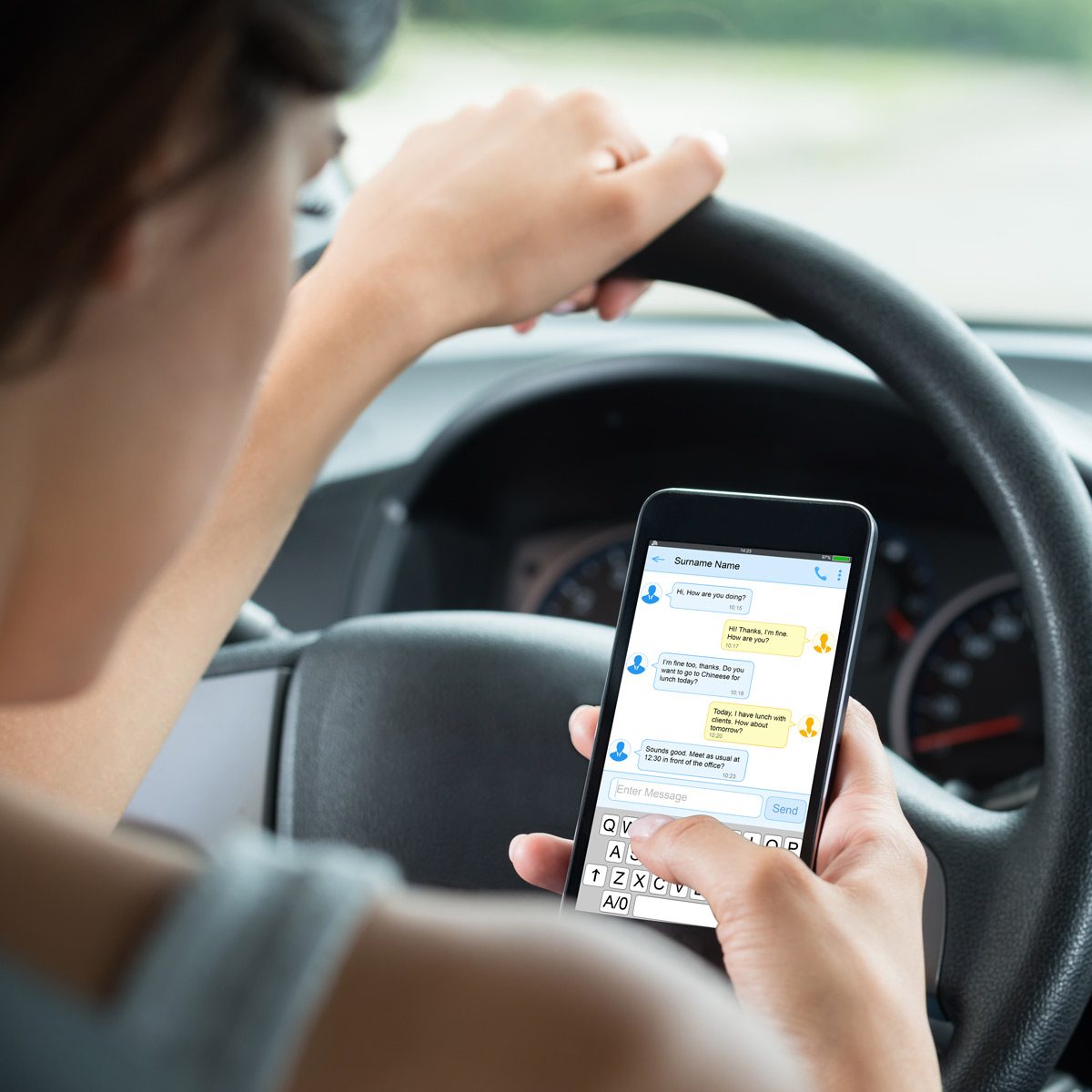 Woman-texting-while-driving-a-car