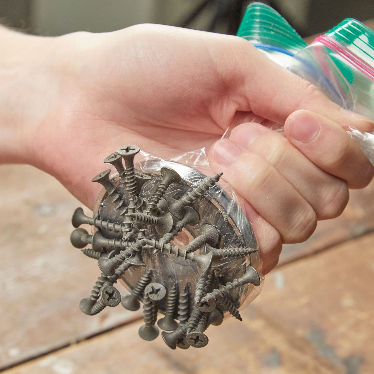 HH pick up a spill of screws with magnet or plastic bag