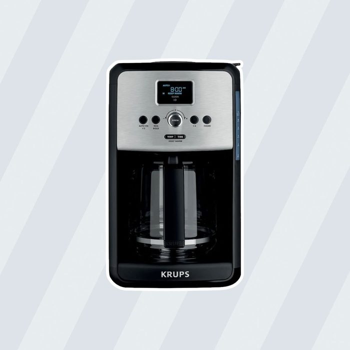 A coffee maker brews coffee, featuring a digital display and control buttons, set against a light gray background with diagonal stripes.