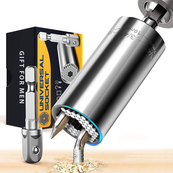 A universal socket tool is drilling into wood, while a box labeled 