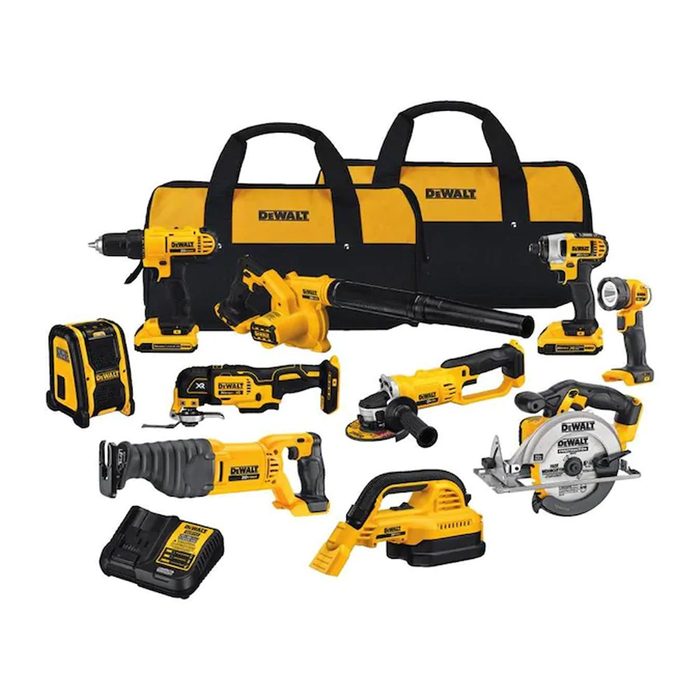 A collection of yellow and black power tools is arranged alongside two carrying bags, showcasing various models designed for construction and DIY projects.