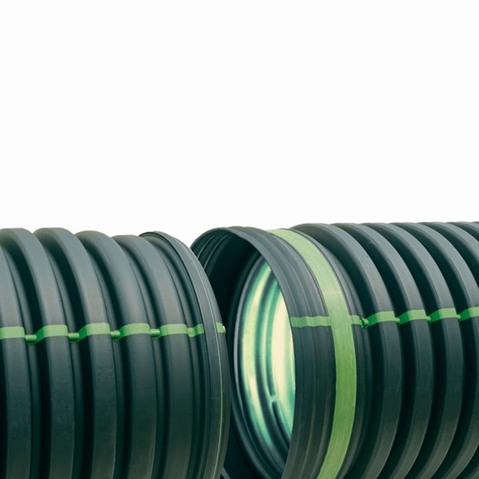 Two dark, ribbed plastic pipes are aligned closely, revealing their inner surfaces. Green markings indicate sections of the pipes, against a plain white background.