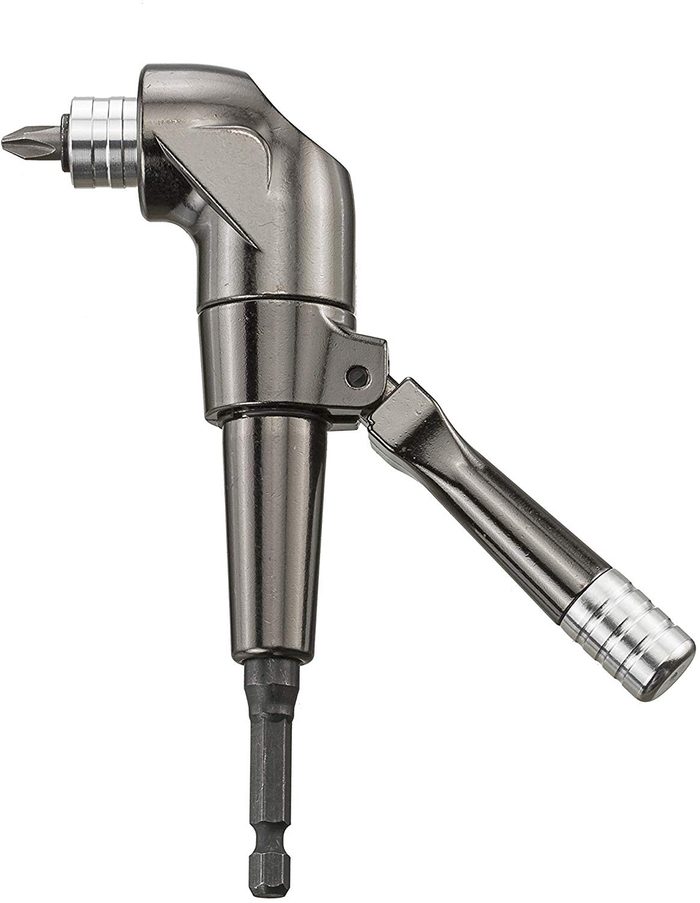 A metallic angle-head screwdriver holds a bit, ready to drive screws, surrounded by neutral space without distinct background elements.