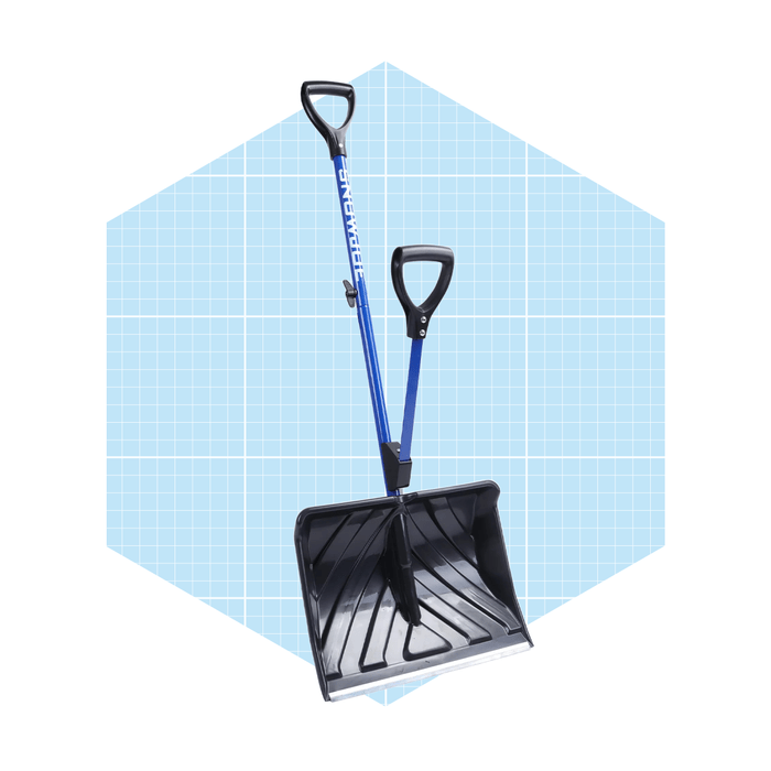 A snow shovel stands upright with a black scoop and blue handles, set against a light blue grid background, indicating a tool designed for clearing snow.