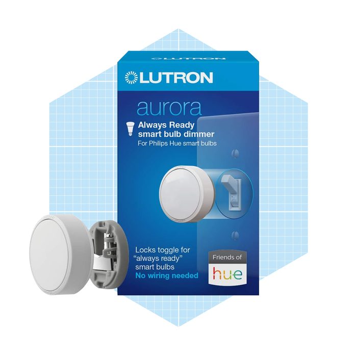 A smart bulb dimmer is displayed, showing a round white dimmer switch and its packaging, which features blue graphics and product specifications for Philips Hue bulbs.