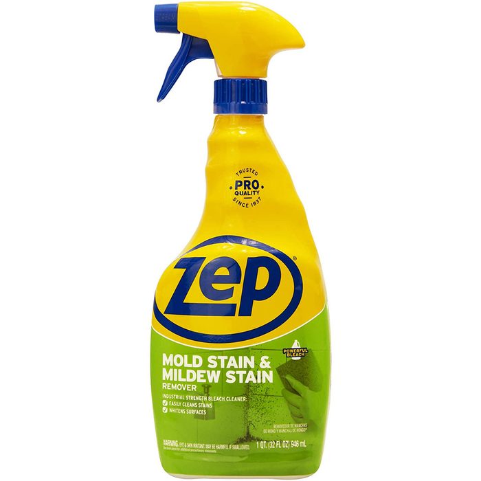 A spray bottle of Zep Mold Stain & Mildew Stain Remover is displayed, featuring a yellow cap and blue label, designed for cleaning stains and mildew.