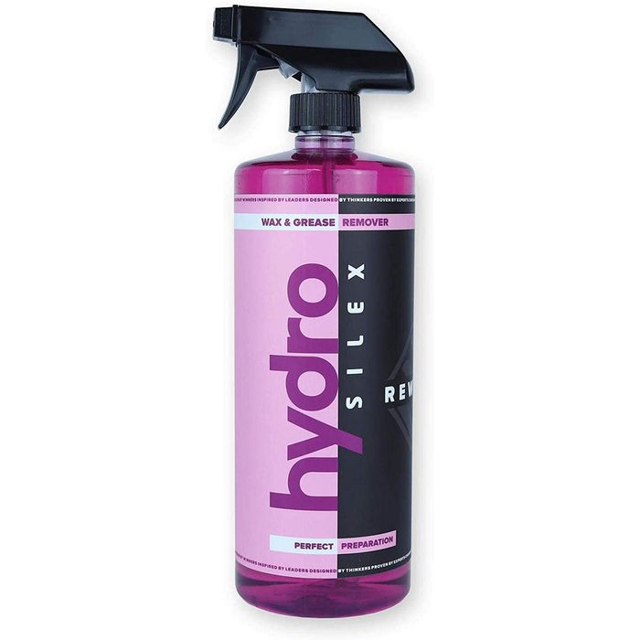 A spray bottle containing a pink liquid labeled 