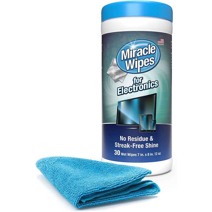 A container of Miracle Wipes for electronics sits next to a blue microfiber cloth, promoting residue-free cleaning for screens in a practical display.
