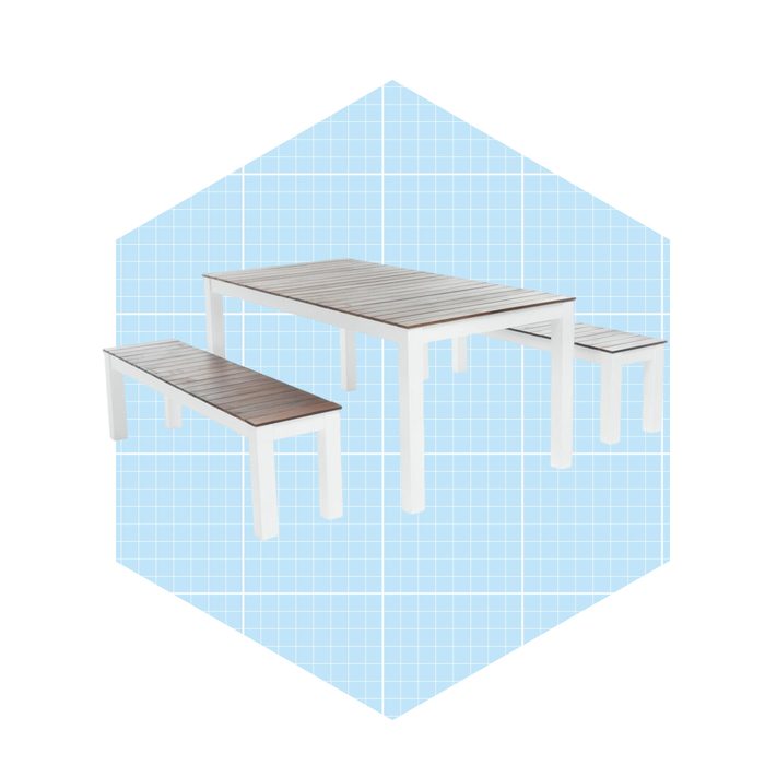 A white wooden table with two matching benches displays a modern design, set against a light blue grid background.
