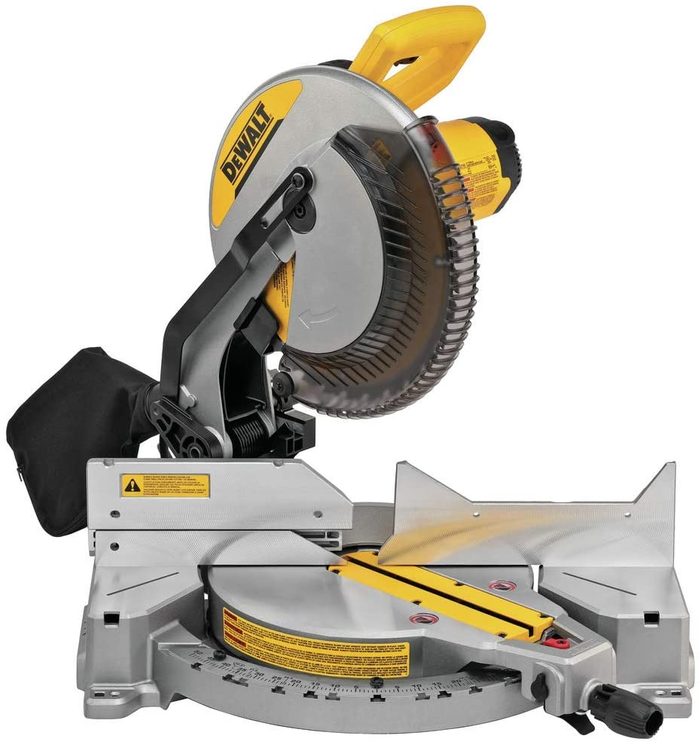 A circular saw with a yellow handle and metal base is positioned, ready for cutting. It is possibly placed on a workbench or flat surface.