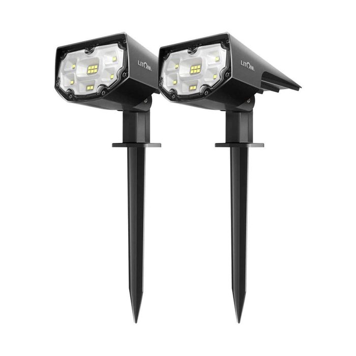Two black outdoor landscape lights stand upright on pointed stakes, designed to illuminate garden or pathway areas with a bright, focused light.