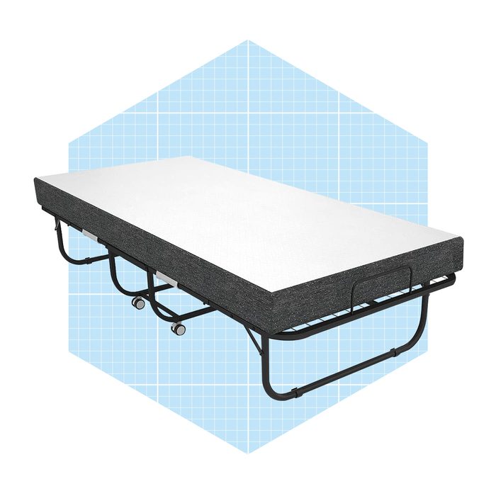 A foldable cot with a black frame and white mattress stands against a light blue grid background, suitable for temporary sleeping arrangements.