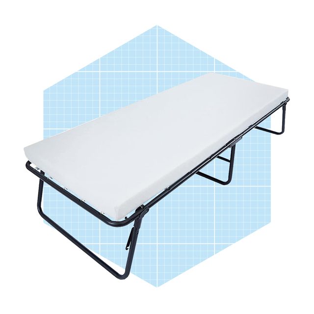 A foldable cot with a white mattress rests on a black metal frame against a light blue grid background, ready for use.