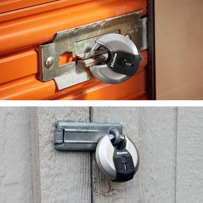 Two padlocks secure different doors. The top padlock is attached to an orange door, while the bottom one secures a gray wooden door.