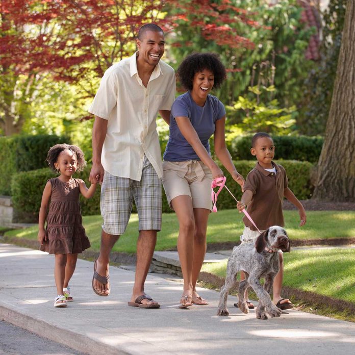 Family walking dog on a leash