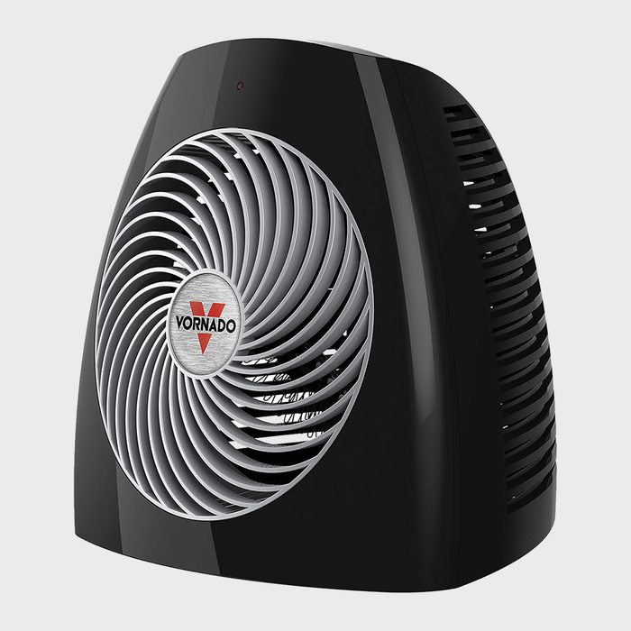 A black Vornado fan circulates air, featuring a distinctive spiral grille design, set against a plain background, emphasizing its sleek appearance and modern functionality.