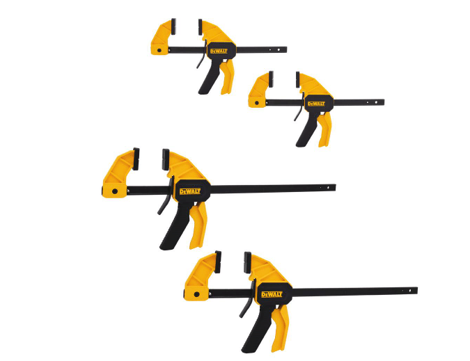 Four clamps with yellow handles and black bars are arranged from smallest to largest, designed for holding objects securely during woodworking or construction tasks.