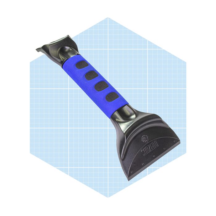 A black ice scraper with a blue grip is positioned against a light blue grid background, designed to remove frost from car windows.
