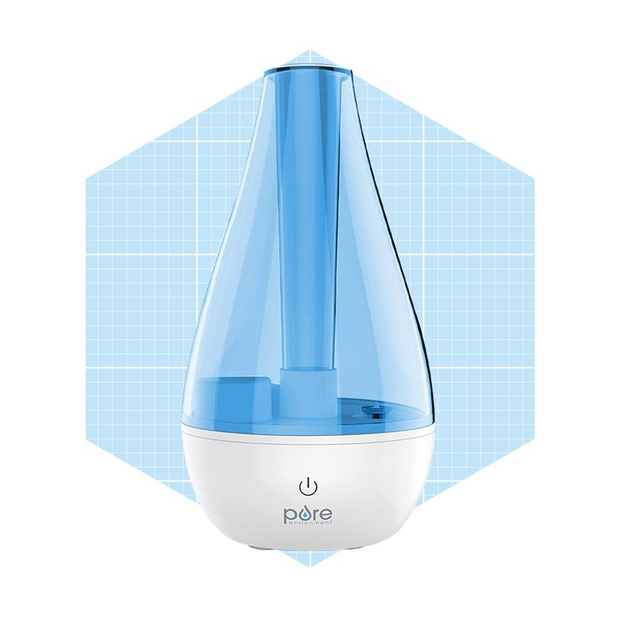 A blue, teardrop-shaped humidifier releases mist from its top, set against a light blue grid background.