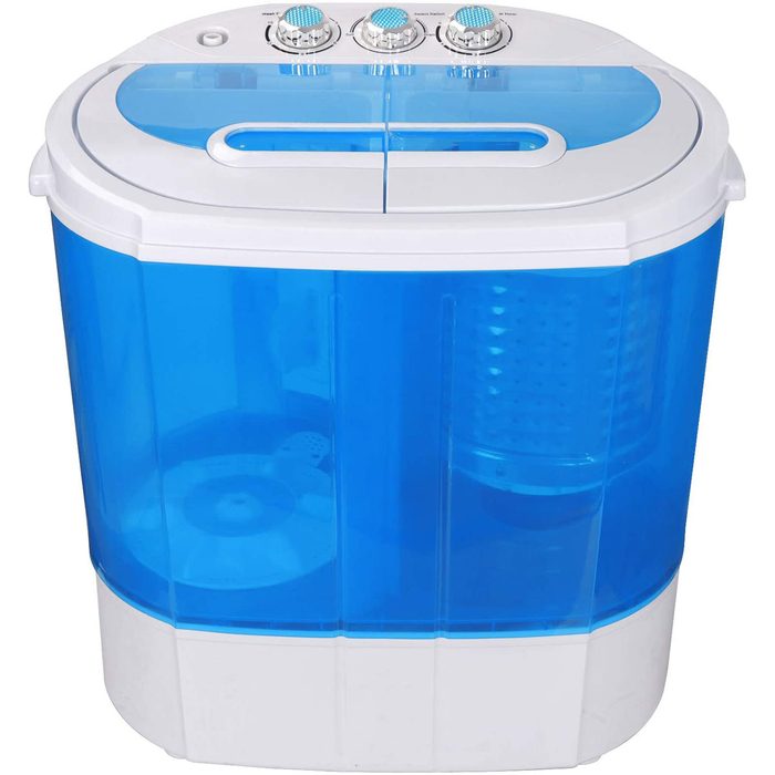 A compact, blue and white washing machine sits on a surface, featuring dials on top for settings and a transparent drum visible inside.