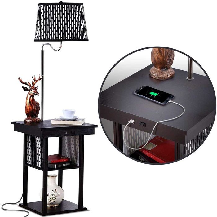 A black lamp table features a deer figurine and a small cup on top, while a phone charges below in a stylish, modern living space.
