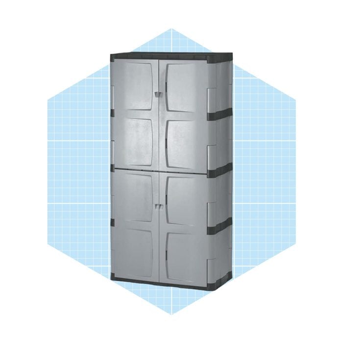 A tall, gray storage cabinet stands upright, featuring four doors for access, against a light blue grid-patterned background.