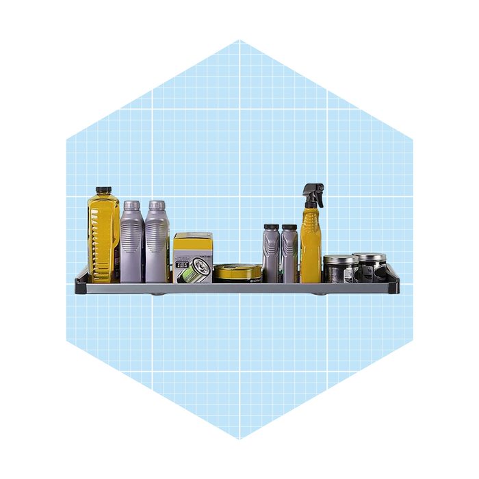 A shelf holds various containers, including bottles and cans, arranged neatly against a light blue grid background, suggesting a tidy storage space.