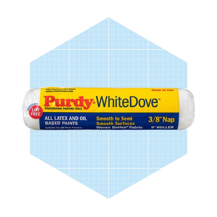 A paint roller labeled "Purdy WhiteDove" rests against a light blue grid background, indicating it