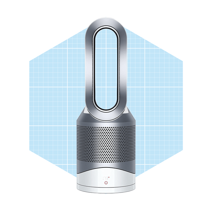 A sleek, modern fan stands upright, circulating air in a spacious, light blue grid-patterned background. Its design features a distinctive elongated loop and silver accents.