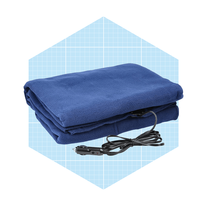 A blue electric blanket is folded neatly with a power cord attached, set against a light blue grid background.