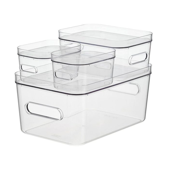 Stacked transparent storage containers rest on a flat surface, showcasing various sizes and shapes, designed for organizing items efficiently.