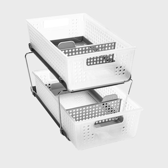 Two transparent, perforated storage baskets are stacked vertically on a silver metallic frame, positioned against a plain gray background.