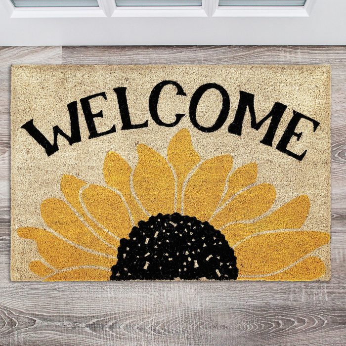 A doormat displays the word 
