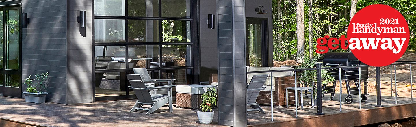 A modern deck features outdoor furniture and a grill, surrounded by trees and natural light, creating a relaxing atmosphere.