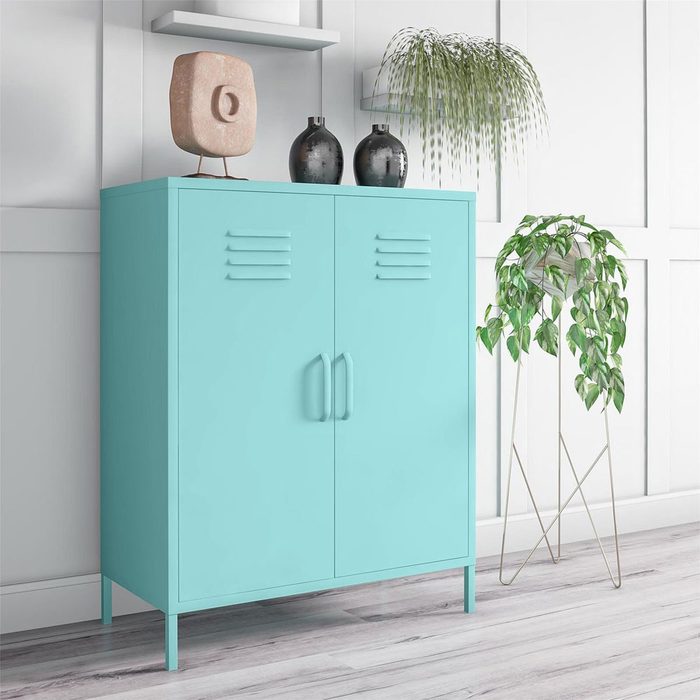 A turquoise storage cabinet stands in a modern interior, adorned with a decorative object and plants, against a light-colored wall and wooden floor.