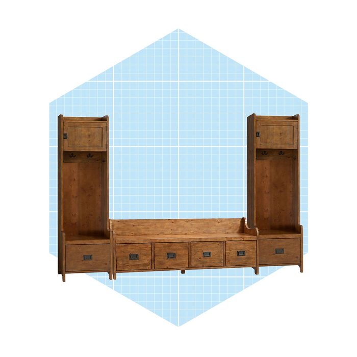 A wooden storage unit features two tall sections with hooks and a lower bench with drawers, set against a light blue grid background.