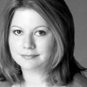 A person with medium-length, slightly wavy hair gazes directly at the viewer, set against a neutral background that emphasizes their facial features.